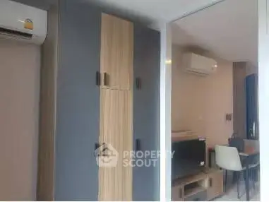Modern living room with stylish furniture and air conditioning unit