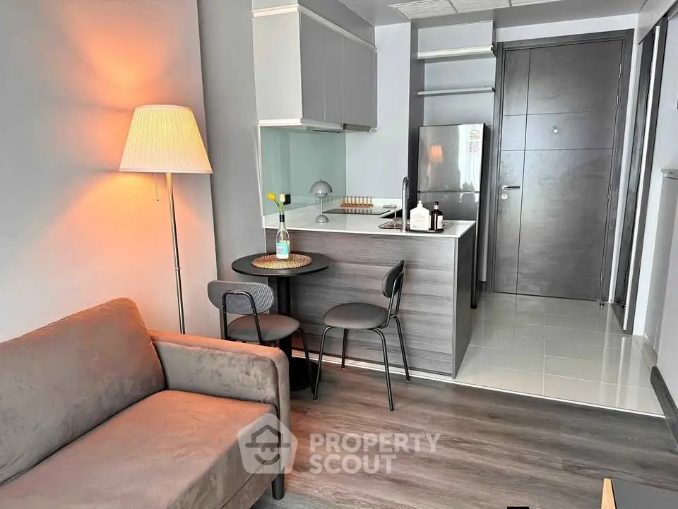 Modern studio apartment with cozy living area and compact kitchen