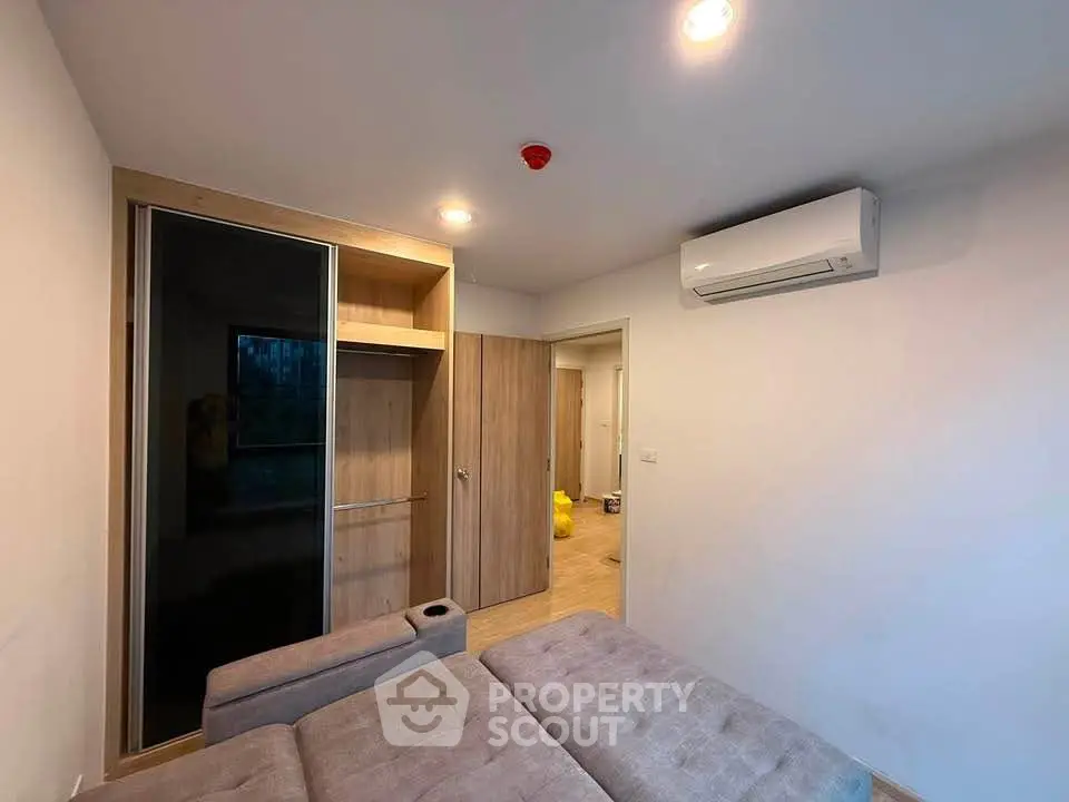 Modern living room with built-in wardrobe and air conditioning unit