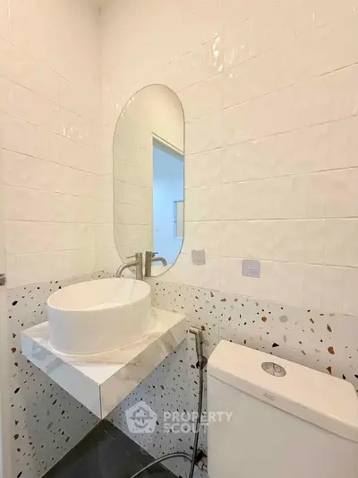 Modern bathroom with stylish sink and terrazzo tiles, perfect for contemporary living.
