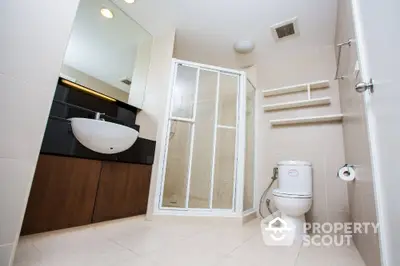 Modern bathroom with sleek fixtures and spacious shower in contemporary home.