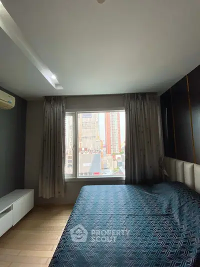 Spacious bedroom with city view and modern decor