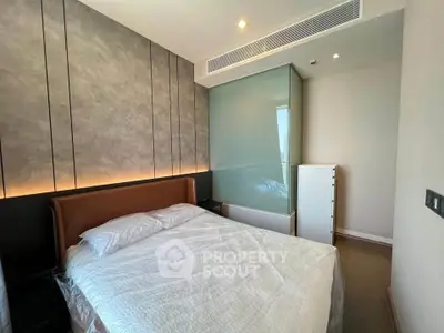 Modern bedroom with stylish decor and ambient lighting in a luxury apartment.