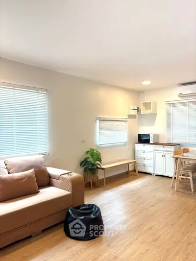 Bright and cozy living room with modern furniture and wooden flooring