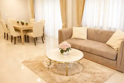 Elegant living room with plush sofa, stylish dining area, and soft lighting for a cozy ambiance.