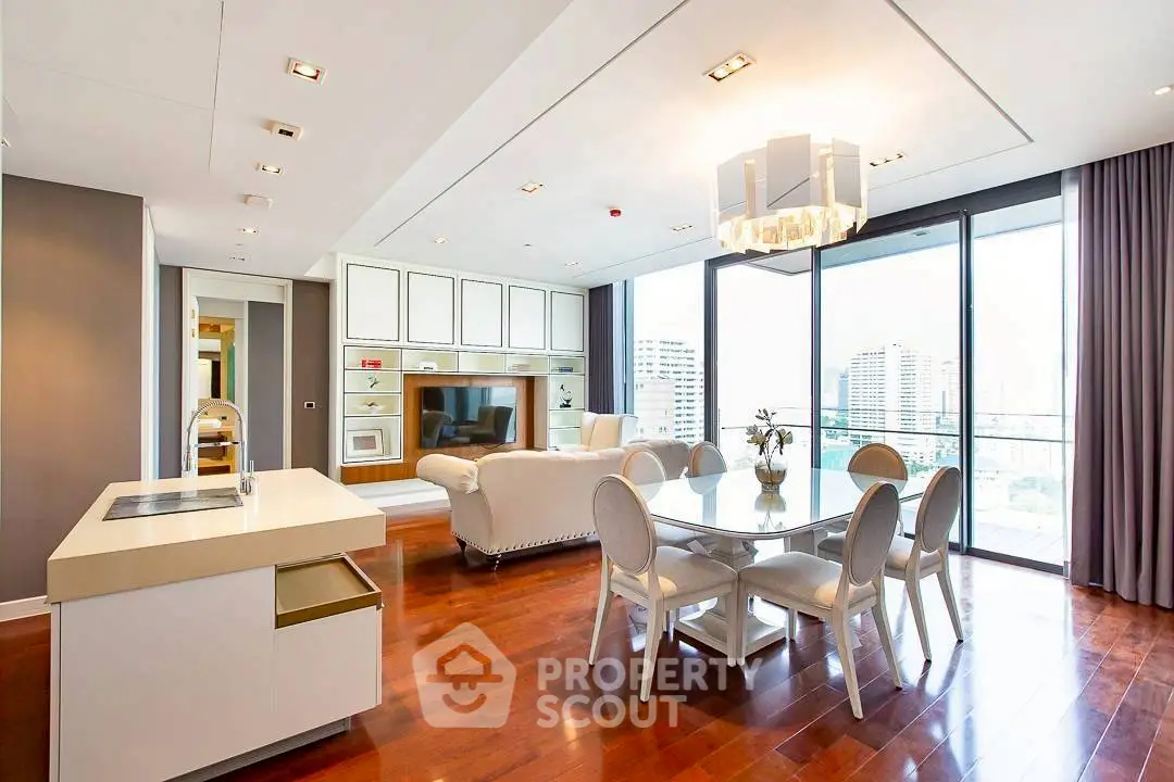 Luxurious open-plan living room with modern kitchen and city view balcony.