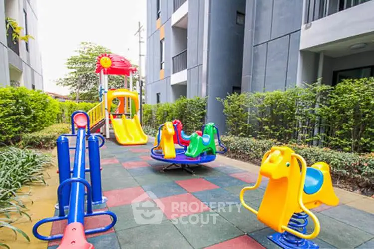 Vibrant playground in modern residential complex with colorful slides and play equipment.