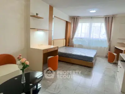 Modern studio apartment with stylish furniture and large window view