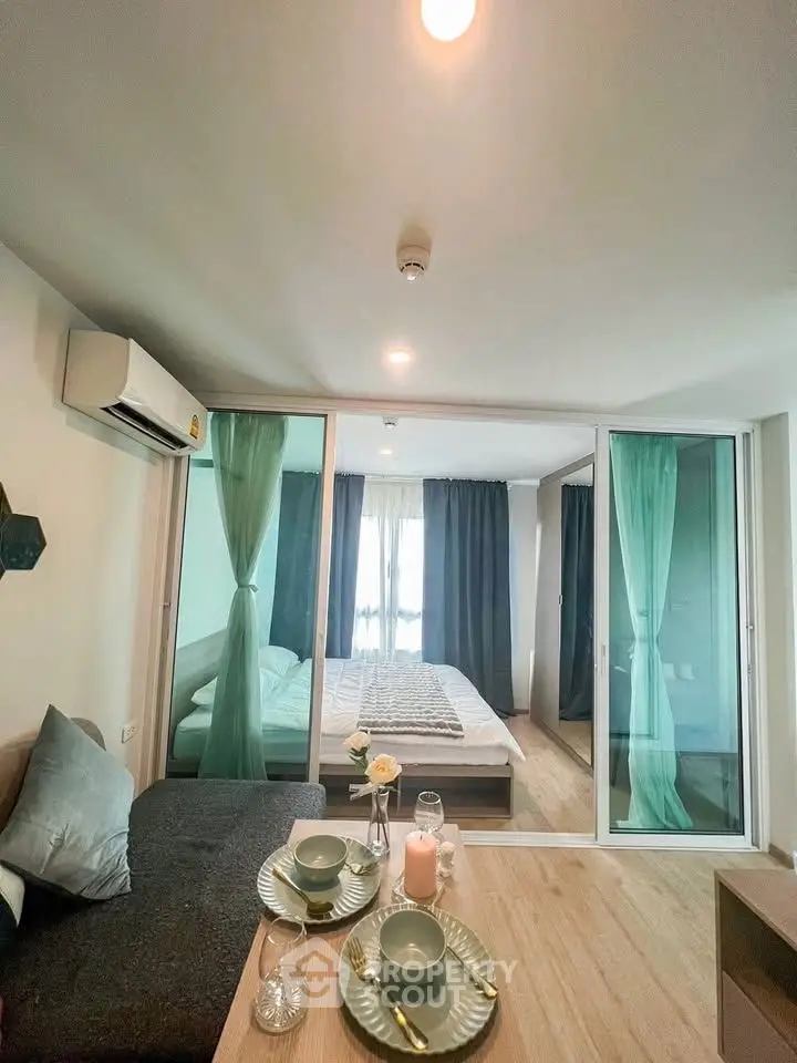 Modern studio apartment with glass partition, cozy living area, and stylish decor
