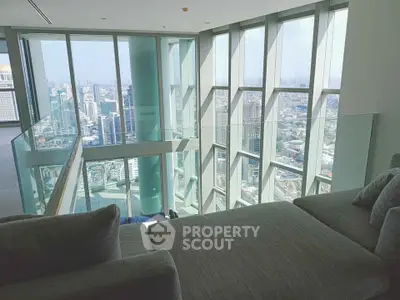 Luxurious high-rise living room with panoramic city views and modern furnishings.