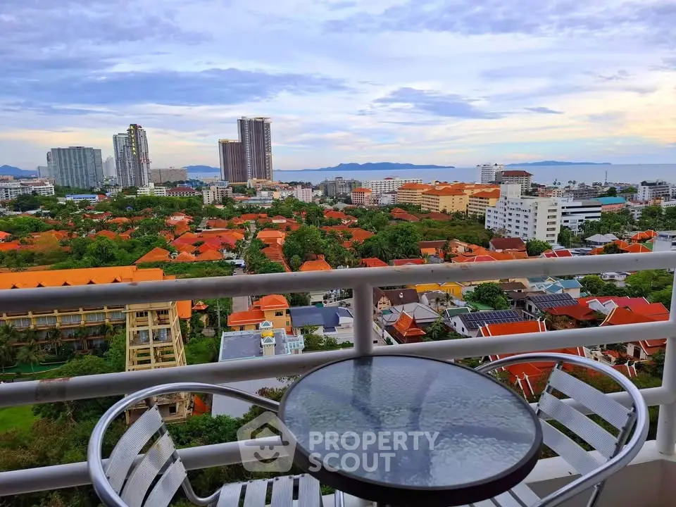 Stunning high-rise balcony view overlooking cityscape and ocean horizon, perfect for urban living.