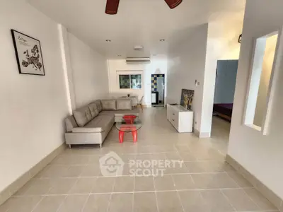 Spacious living room with modern furniture and tiled flooring