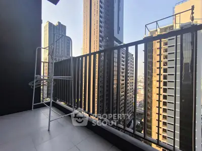 Spacious balcony with stunning cityscape views in modern high-rise building.