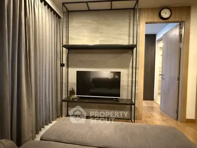 Modern living room with sleek TV stand and cozy sofa, perfect for relaxation and entertainment.