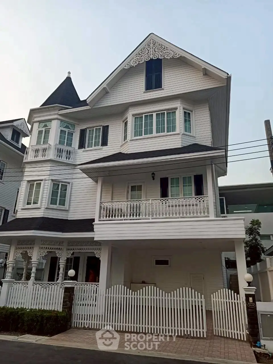 Charming Victorian-style house with intricate detailing and spacious balconies in a serene neighborhood.