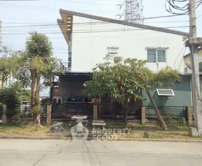 Modern two-story house with unique roof design and lush garden