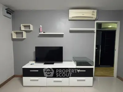 Modern living room with sleek TV stand and wall-mounted shelves