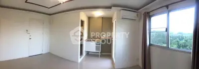 Spacious living room with large window and air conditioning in modern apartment.