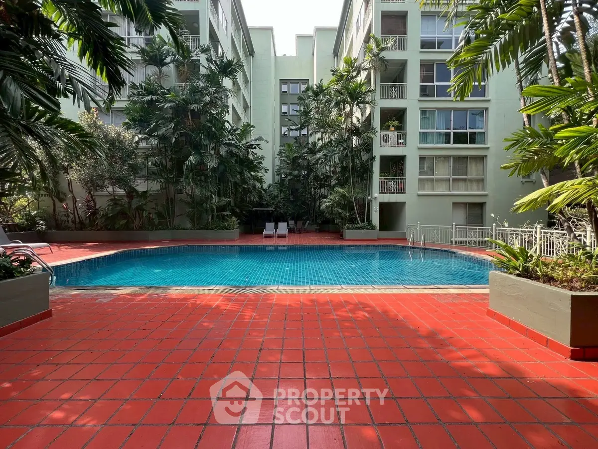 Stunning residential pool area with lush greenery and modern architecture.