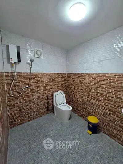 Modern bathroom with tiled walls and shower in real estate property