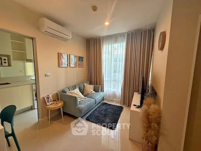Cozy living room with modern decor and natural light in a stylish apartment.