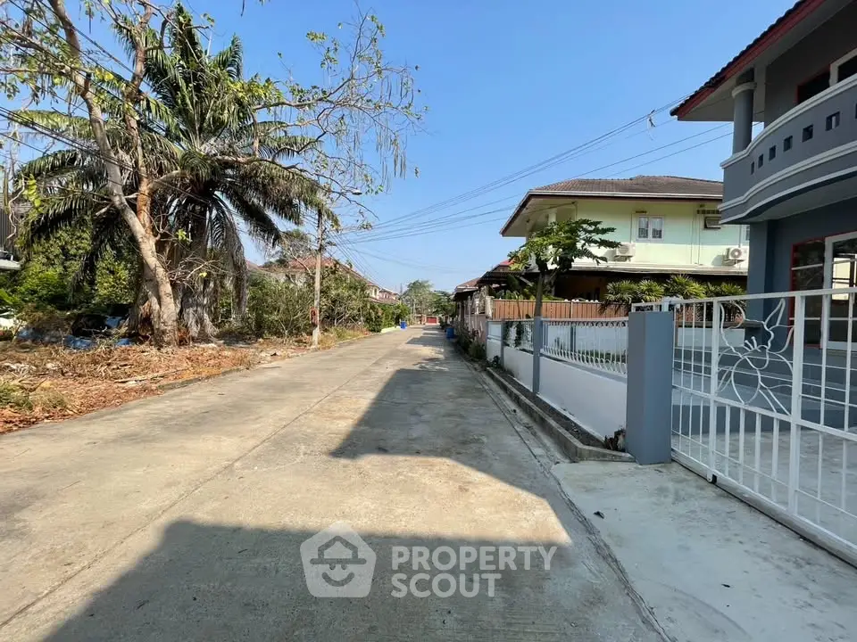 Charming suburban street view with modern houses and lush greenery, ideal for family living.