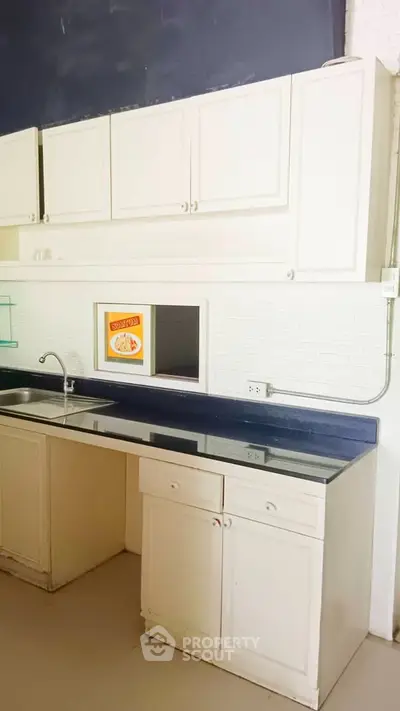 Spacious kitchen with modern cabinetry and sleek countertops, perfect for culinary enthusiasts.