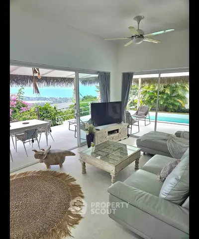 Luxurious living room with ocean view, modern furniture, and spacious balcony access.