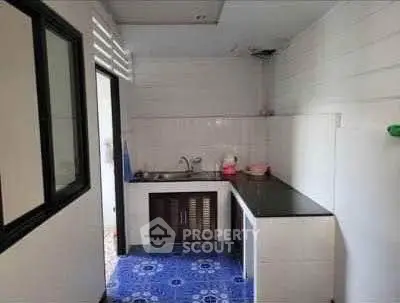 Compact kitchen with modern design and blue patterned floor tiles
