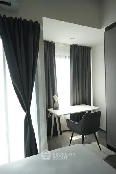 Modern study nook with sleek desk and chair, surrounded by elegant curtains and natural light.