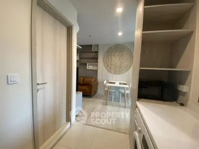 Modern apartment interior with open layout, featuring a cozy living area and stylish kitchen.