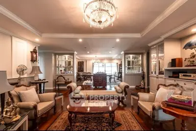 Luxurious living room with elegant chandelier and classic furniture, perfect for sophisticated gatherings.