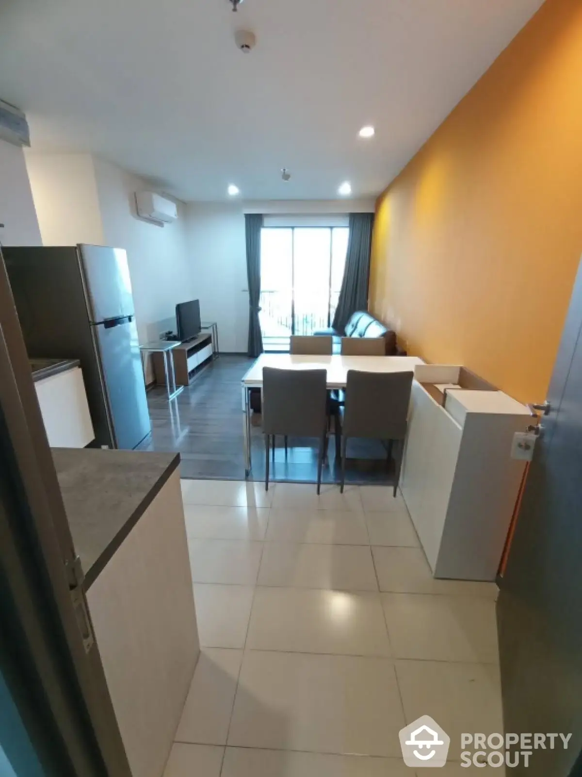 Modern open-layout living room with dining area and balcony view