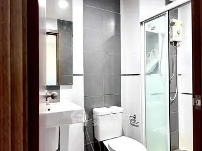 Modern bathroom with sleek design, featuring a shower enclosure and contemporary fixtures.