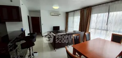 Spacious living room with modern furniture and large windows for natural light.