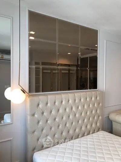 Luxurious bedroom with elegant tufted headboard and modern lighting