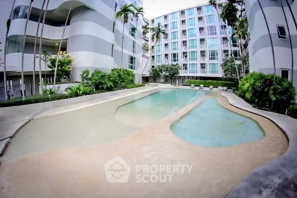 Modern apartment complex with stylish pool and lush greenery