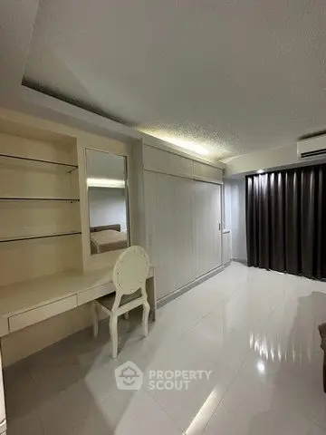 Spacious bedroom with built-in wardrobe and elegant vanity desk