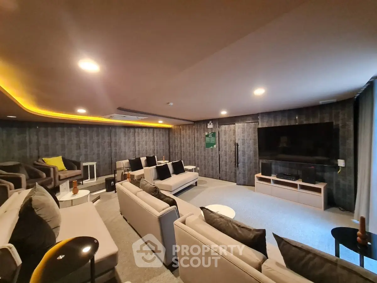 Luxurious home theater room with plush seating and large flat-screen TV