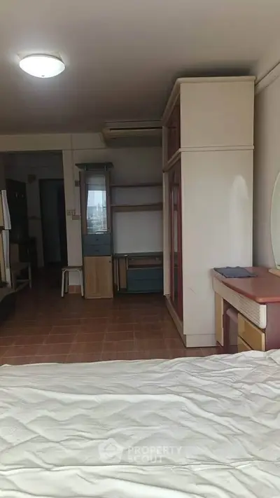 Spacious bedroom with modern furniture and ample natural light