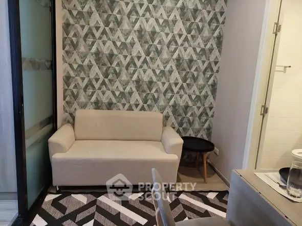 Chic modern living room with geometric wallpaper and cozy beige sofa