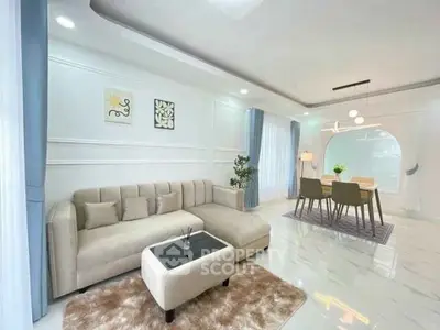 Elegant living and dining area with modern decor and natural light