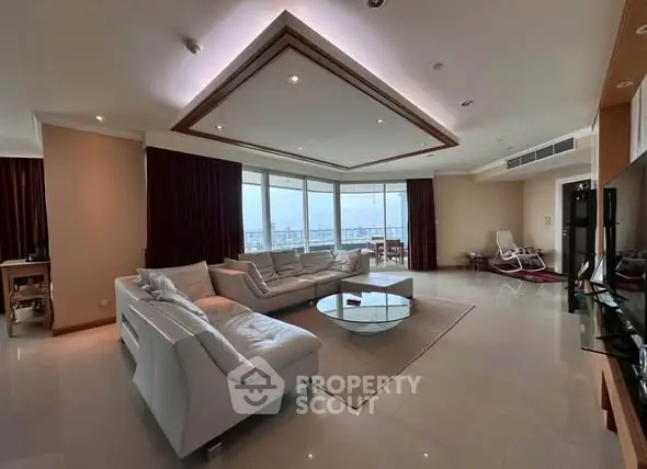 Spacious modern living room with panoramic city views and elegant furnishings.