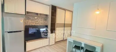 Modern living room with sleek storage and dining area