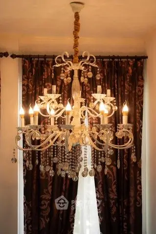 Elegant chandelier in a luxurious living room with ornate curtains