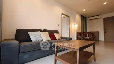 Modern living room with cozy sofa and wooden coffee table in a stylish apartment.
