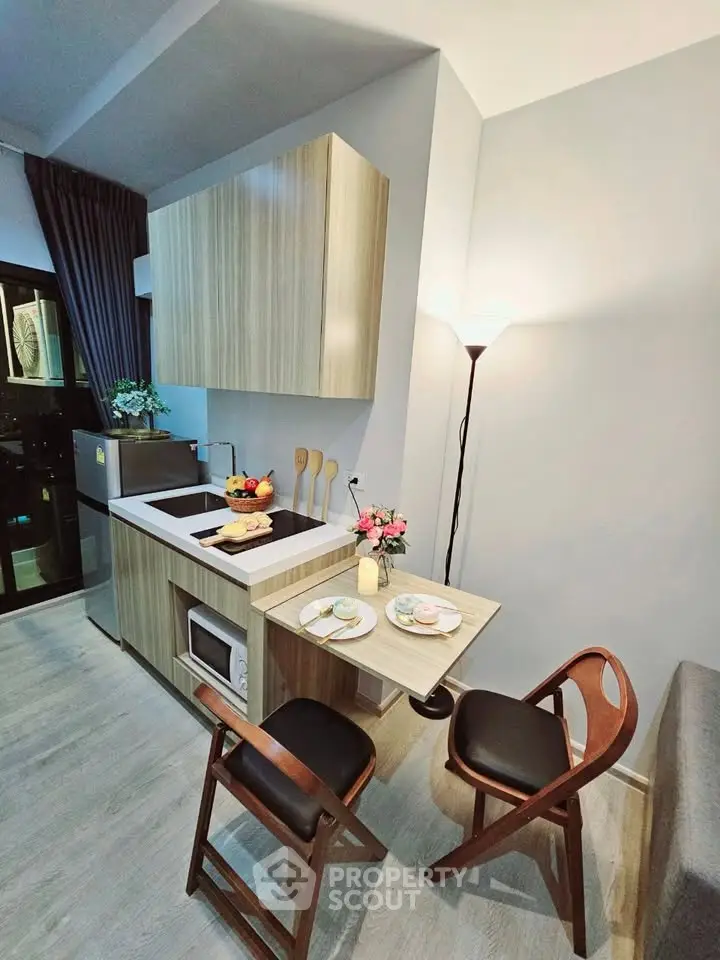 Modern compact kitchen with stylish wooden cabinets and cozy dining area