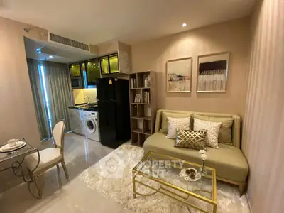 Chic modern living room with elegant decor, featuring a cozy sofa, stylish shelving, and a compact kitchen area.