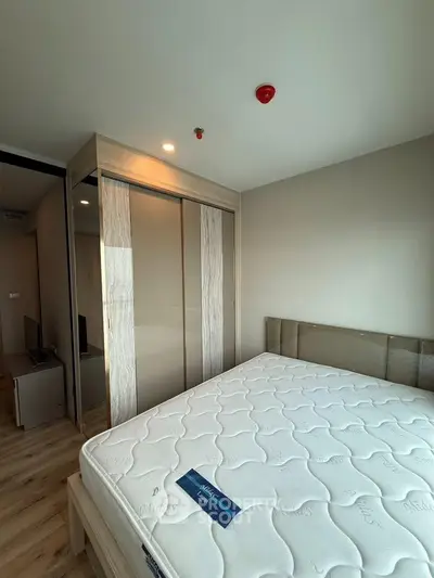 Modern bedroom with sleek wardrobe and comfortable mattress in a stylish apartment.