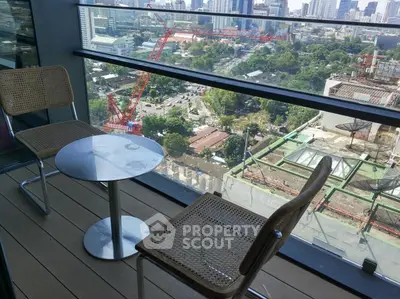 Stunning city view from modern balcony with stylish seating, perfect for relaxation.